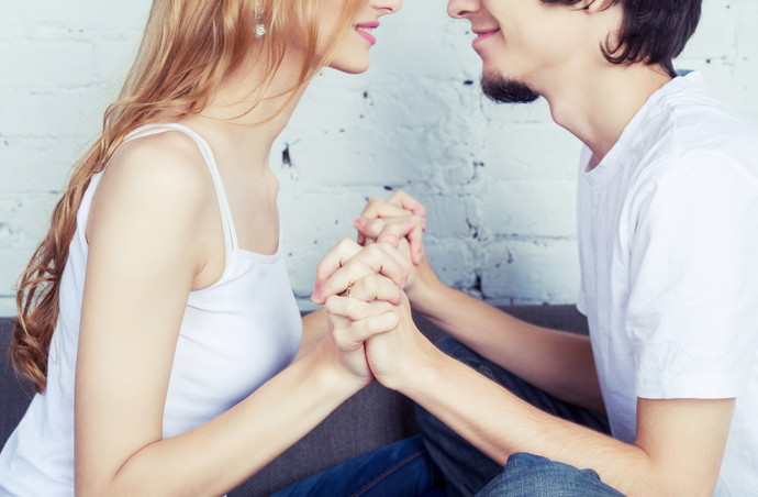 happy young couple at home, focus on the hands