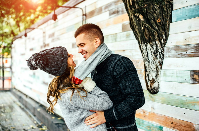 Young happy couple have fun in the park