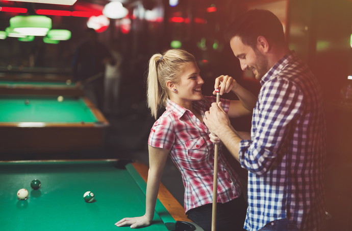 Couple playing snooker together